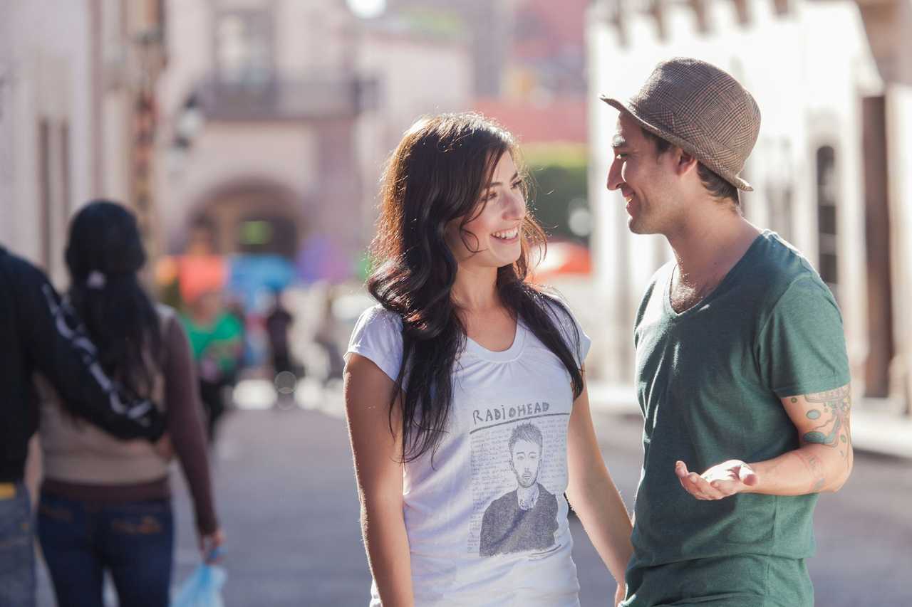 young woman and man in a street during a date preparing for their first kiss