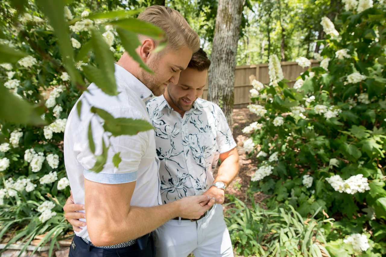 couple of boyfriends walking in a tree park on Valentine's Day saying Valentine messages for boyfriend to each other