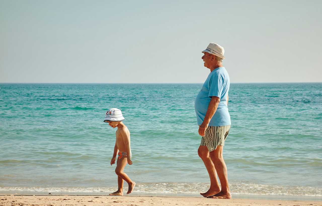 grandfather and grandson walking on the beach on a sunny valentine's day sending wishes