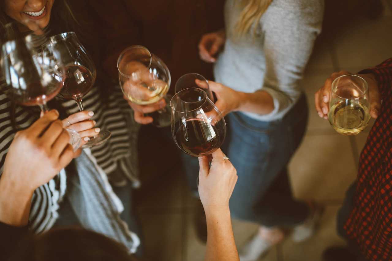 friends toasting with wine glasses at night exchanging good night, friends messages